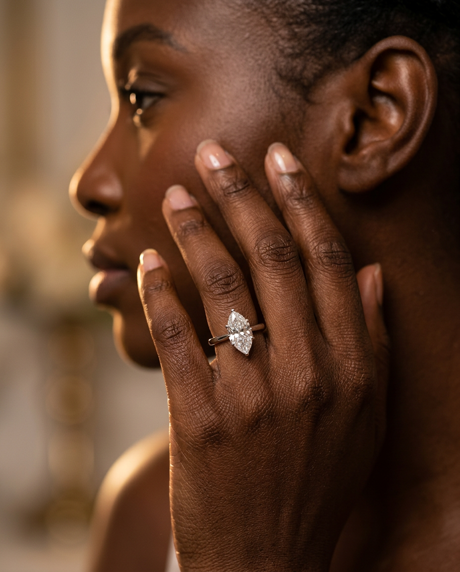 Mira marquise ring on a model's hand — held to face